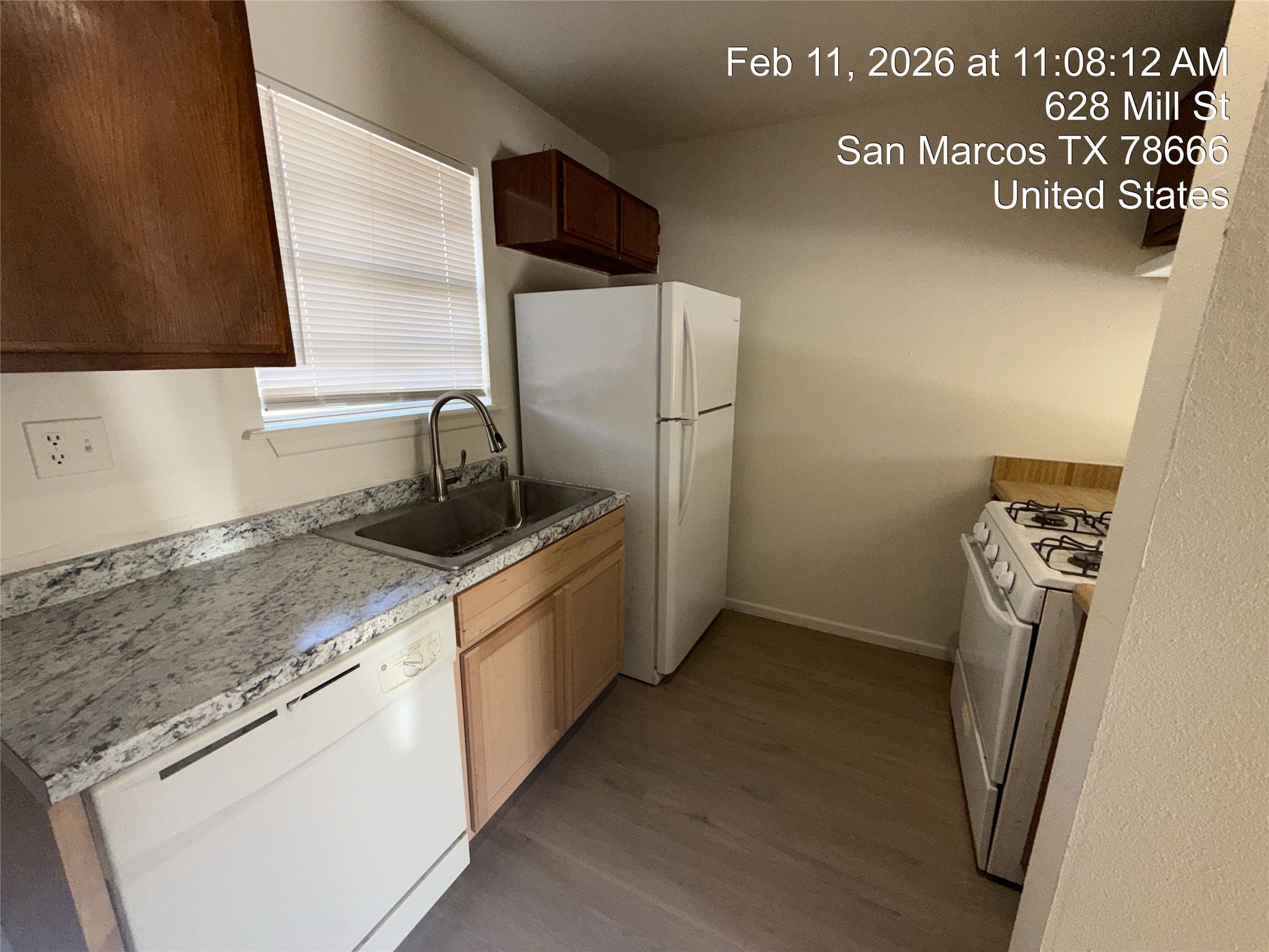 628 Mill Street, Unit B San Marcos, TX 78666 - Photo 2 of 13 Kitchen featuring white appliances and dark wood-type flooring