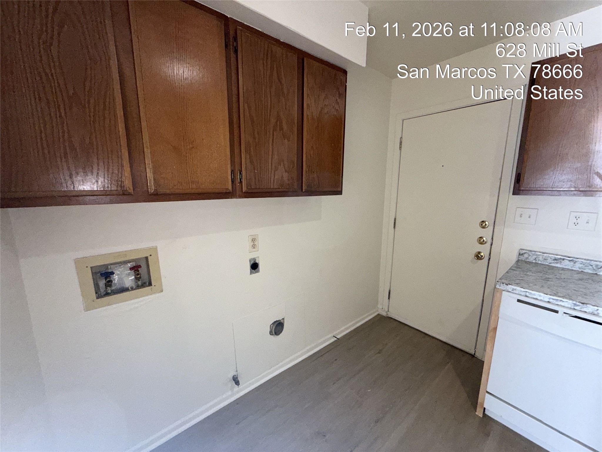628 Mill Street, Unit B San Marcos, TX 78666 - Photo 5 of 13 Laundry room featuring dark wood finished floors, hookup for a washing machine, cabinet space, and electric dryer hookup
