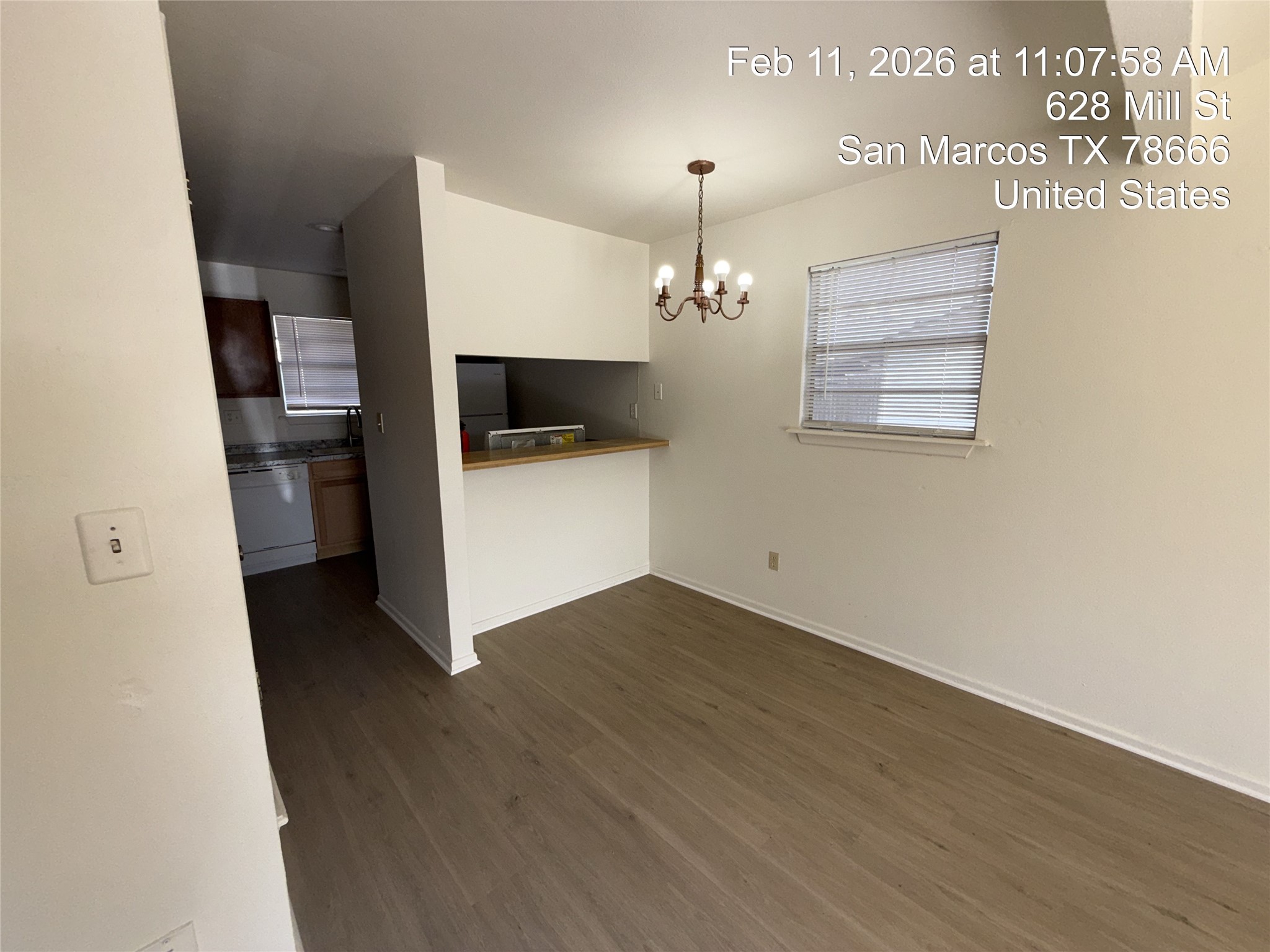 628 Mill Street, Unit B San Marcos, TX 78666 - Photo 9 of 13 Unfurnished dining area with hanging lights and dark wood-style floors