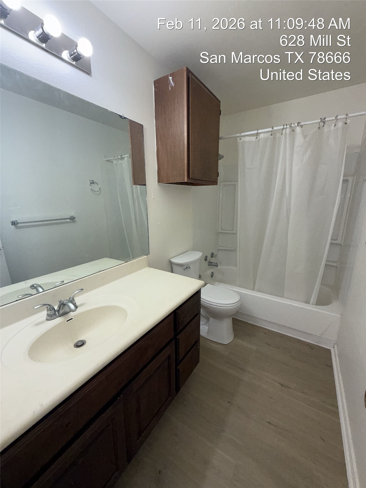 628 Mill Street, Unit B San Marcos, TX 78666 - Photo 10 of 13 Full bathroom with shower / bath combo with shower curtain, vanity, and dark wood finished floors