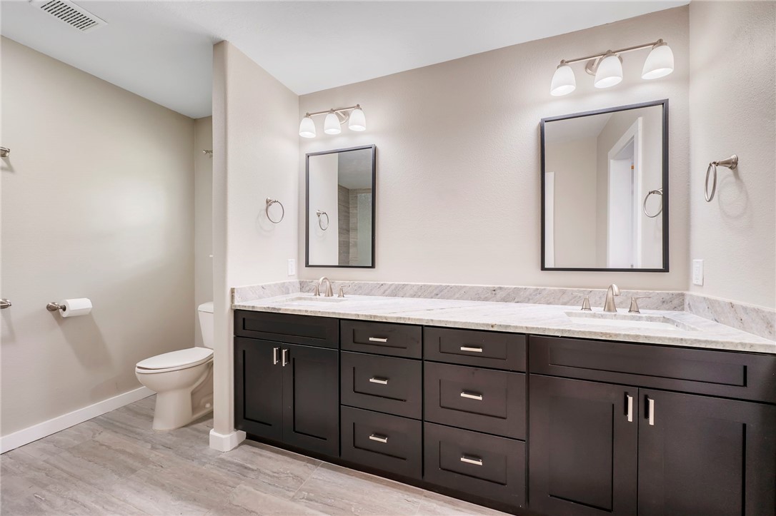 304 Dunn Street Bryan, TX 77801 - Photo 11 of 29 Primary bathroom featuring double vanity, granite