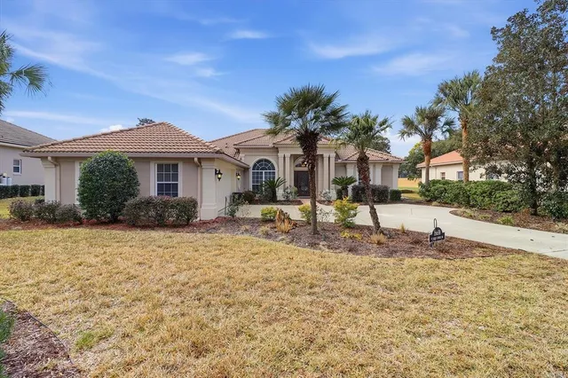 a view of a swimming pool with a yard and lake view