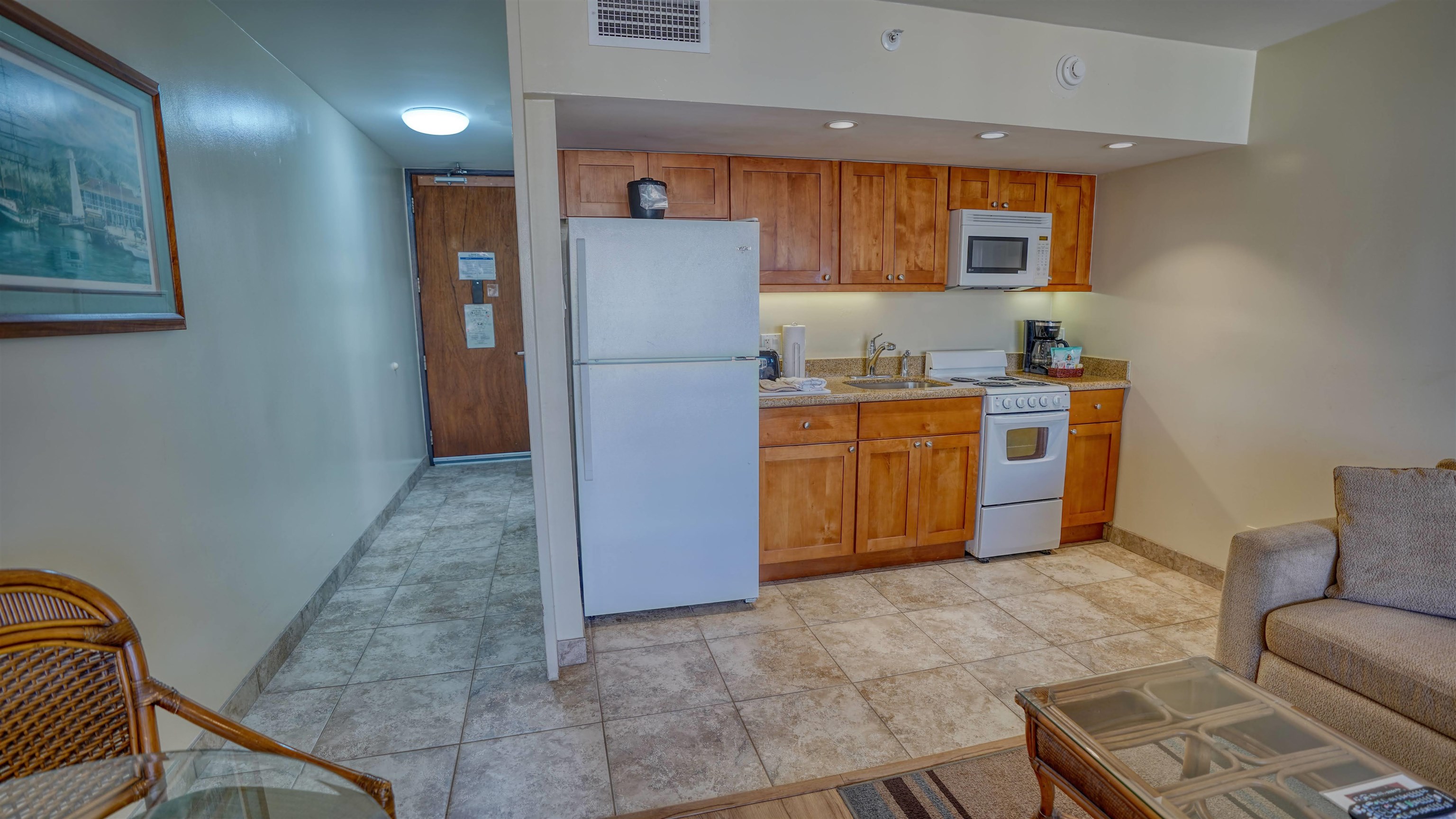 4365 Lower Honoapiilani Road, Unit 1018 Lahaina, HI 96761 - Photo 11 of 35 a kitchen with stainless steel appliances granite countertop a stove a sink a refrigerator with grey cabinets