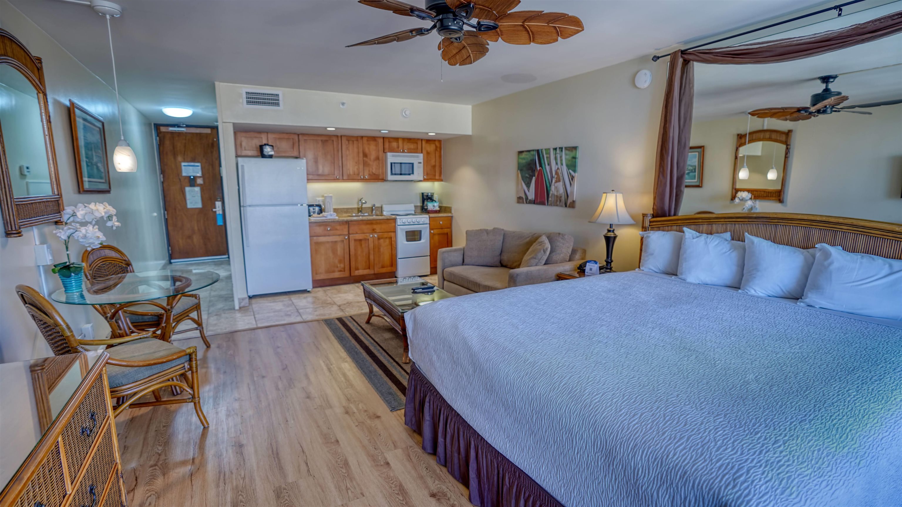 4365 Lower Honoapiilani Road, Unit 1018 Lahaina, HI 96761 - Photo 13 of 35 a bedroom with furniture and a wooden floor