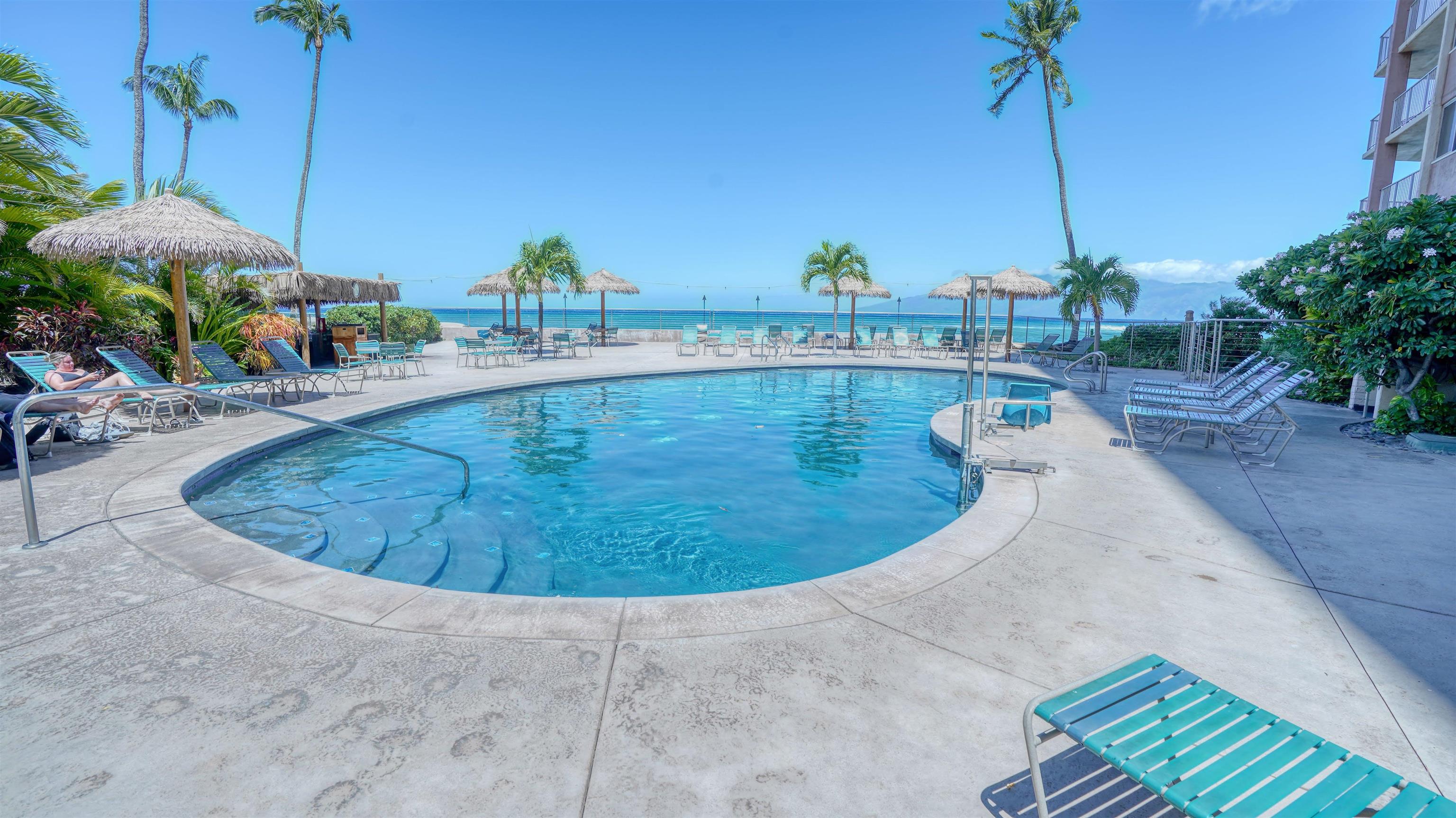 4365 Lower Honoapiilani Road, Unit 1018 Lahaina, HI 96761 - Photo 29 of 35 a view of a swimming pool with a lounge chairs