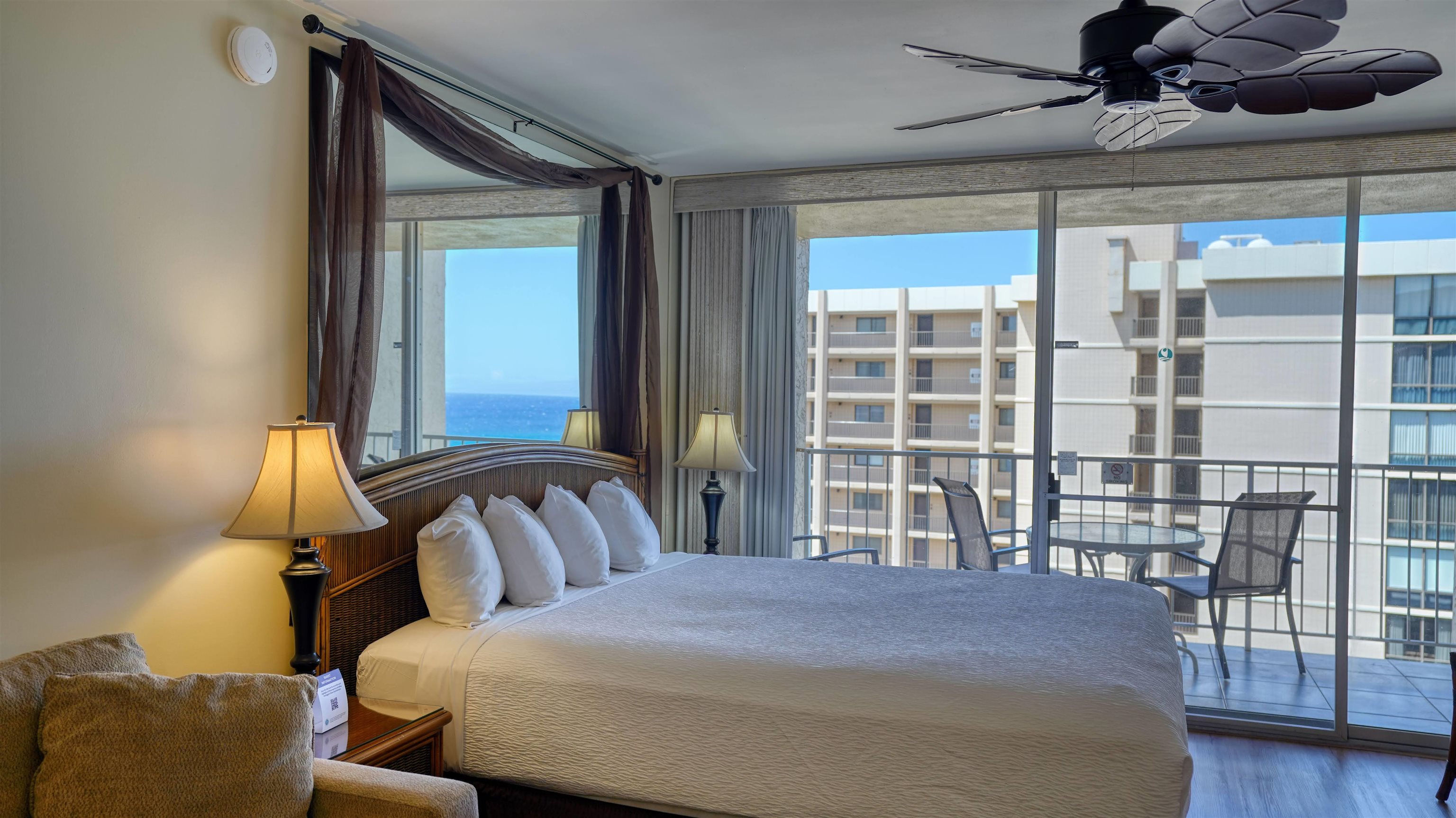 4365 Lower Honoapiilani Road, Unit 1018 Lahaina, HI 96761 - Photo 3 of 35 a bedroom with a bed and glass window