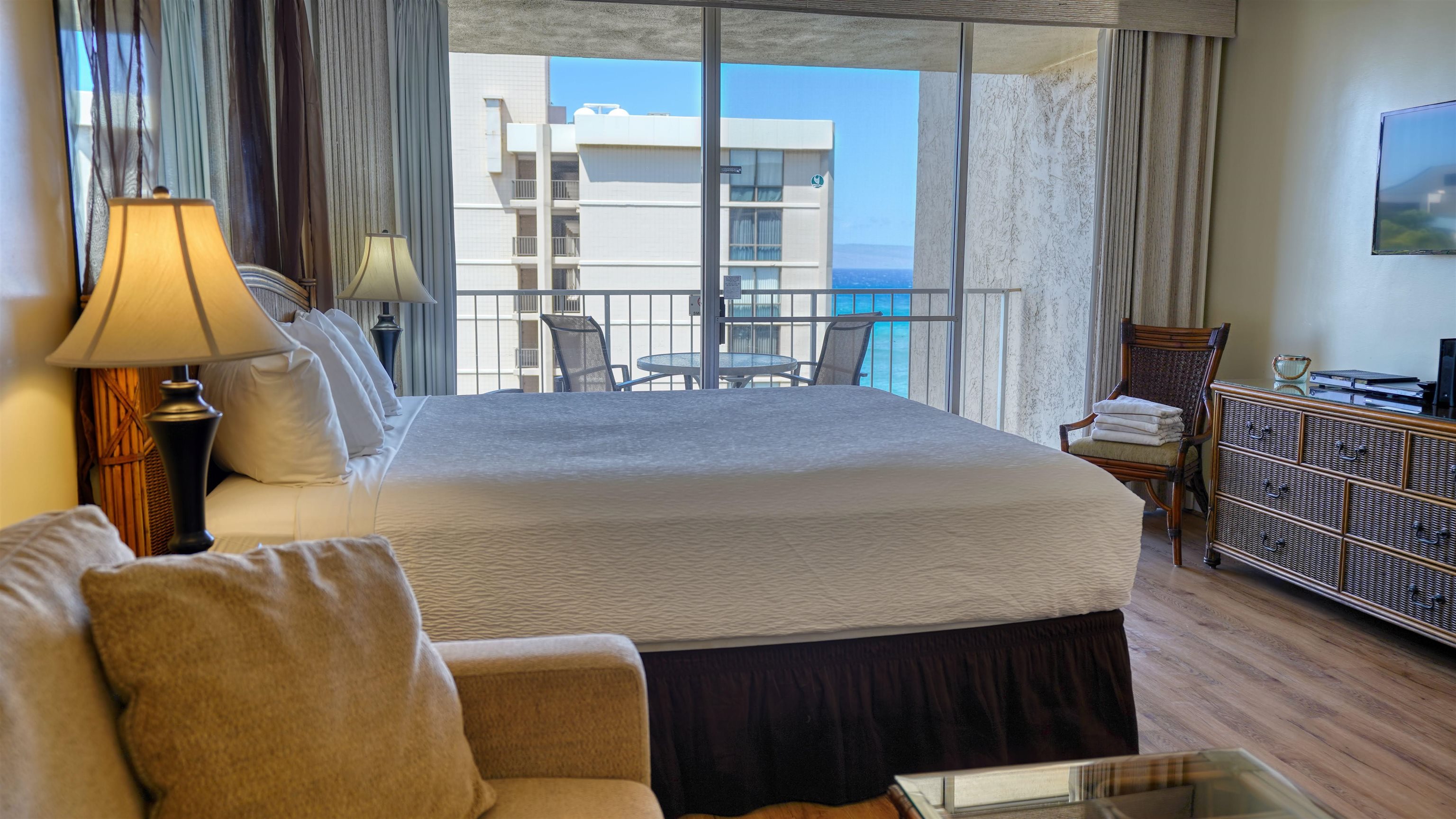 4365 Lower Honoapiilani Road, Unit 1018 Lahaina, HI 96761 - Photo 6 of 35 a bedroom with a bed and wooden floor