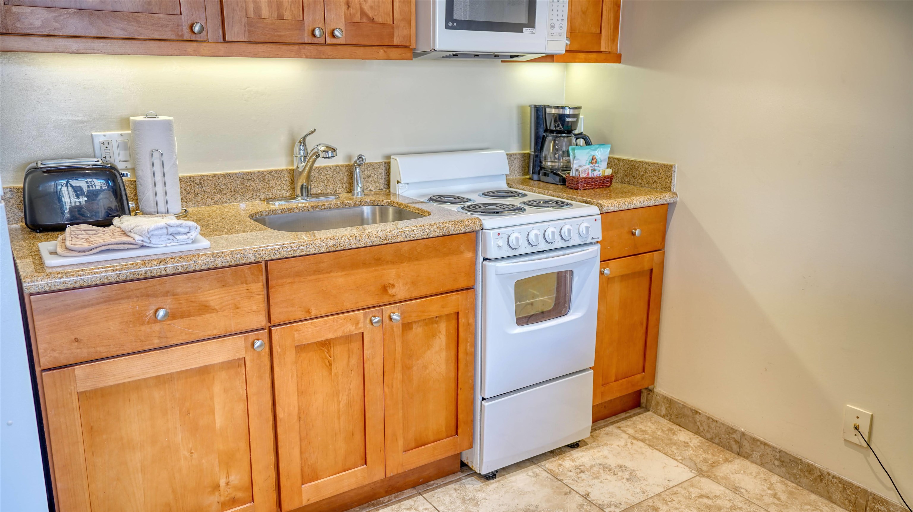 4365 Lower Honoapiilani Road, Unit 1018 Lahaina, HI 96761 - Photo 7 of 35 a kitchen with stainless steel appliances granite countertop a sink stove and cabinets
