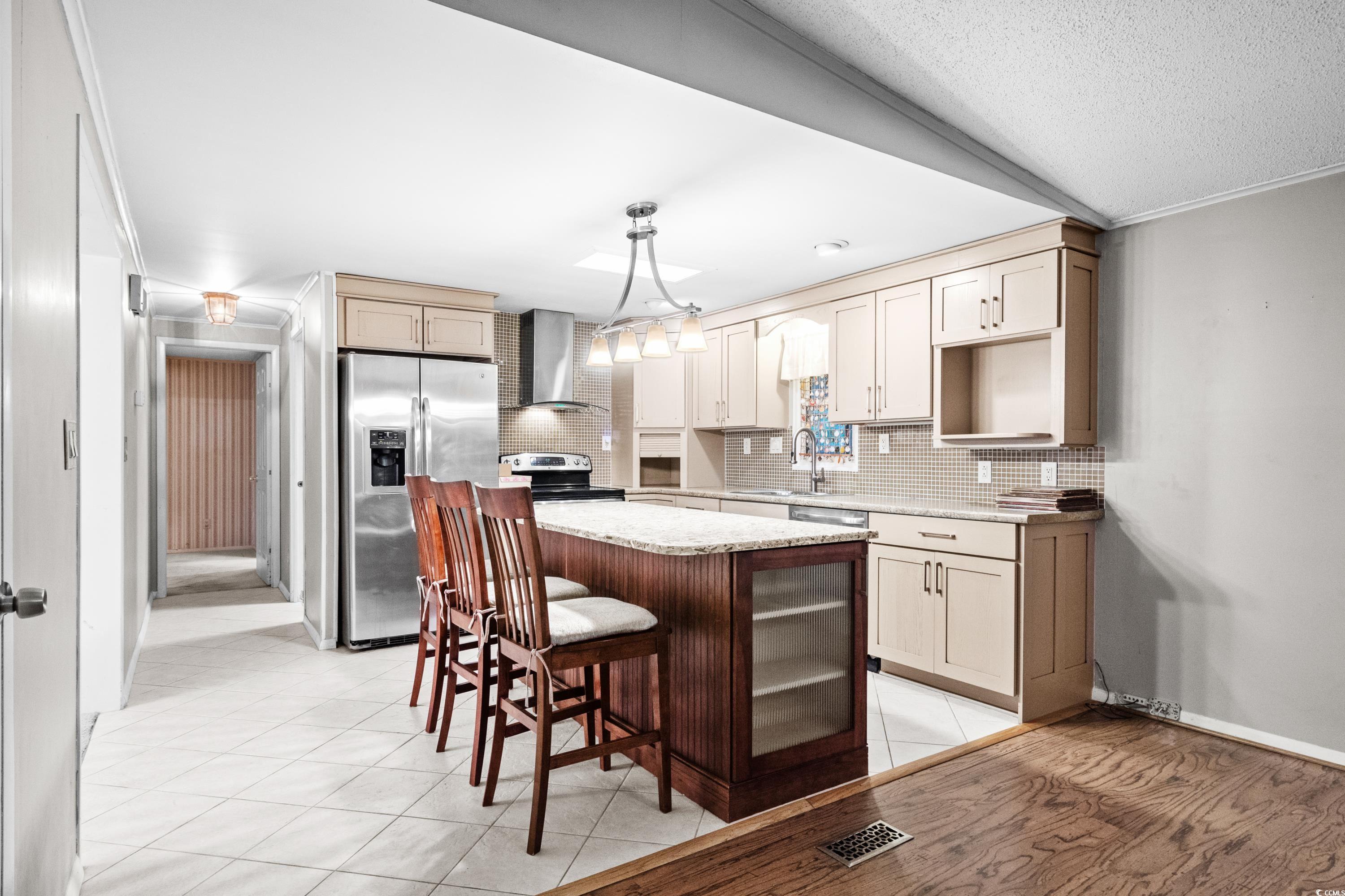 808 Carolina Drive Murrells Inlet, SC 29576 - Photo 15 of 40 Kitchen with sink, vaulted ceiling, wall chimney e