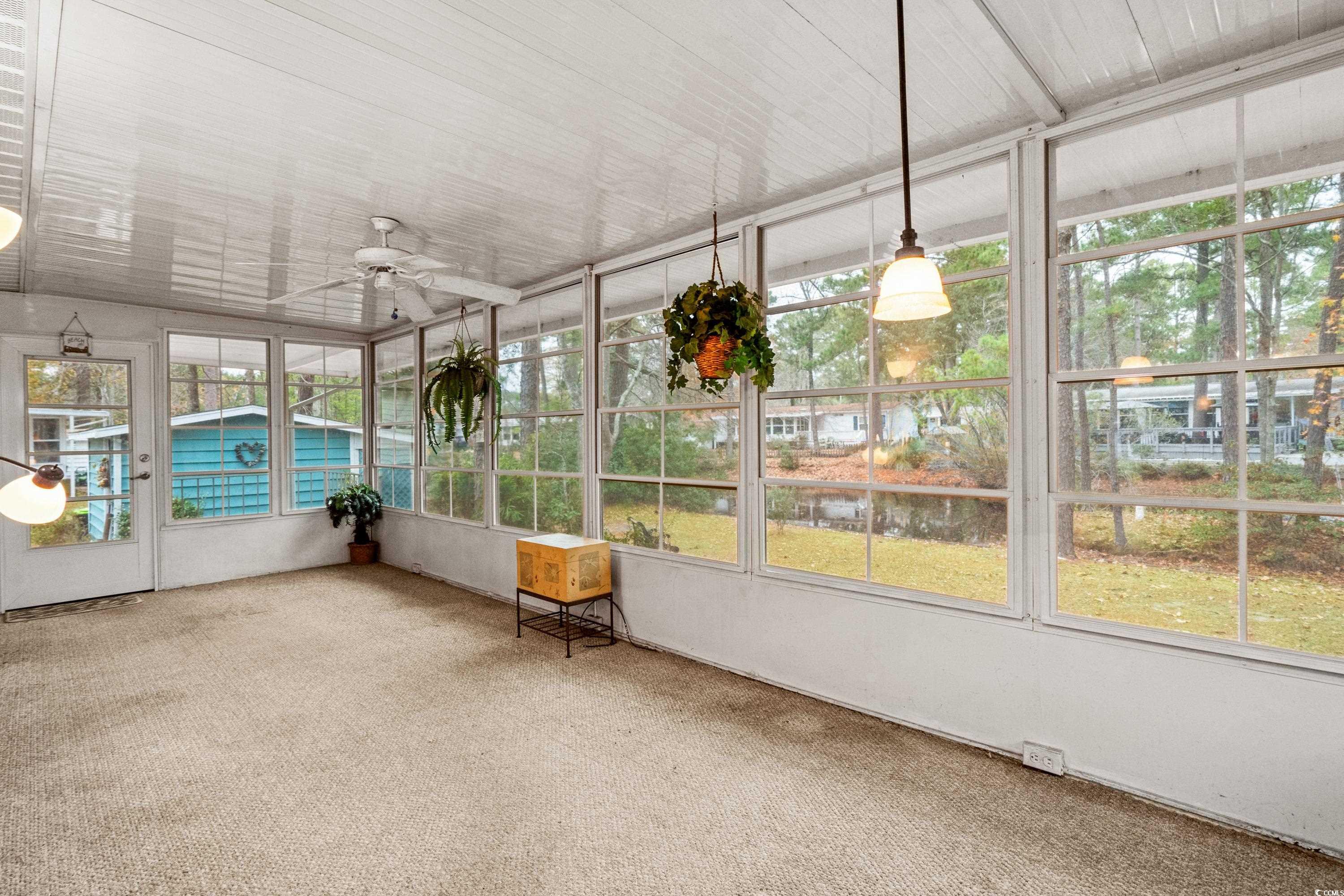 808 Carolina Drive Murrells Inlet, SC 29576 - Photo 18 of 40 Unfurnished sunroom with ceiling fan