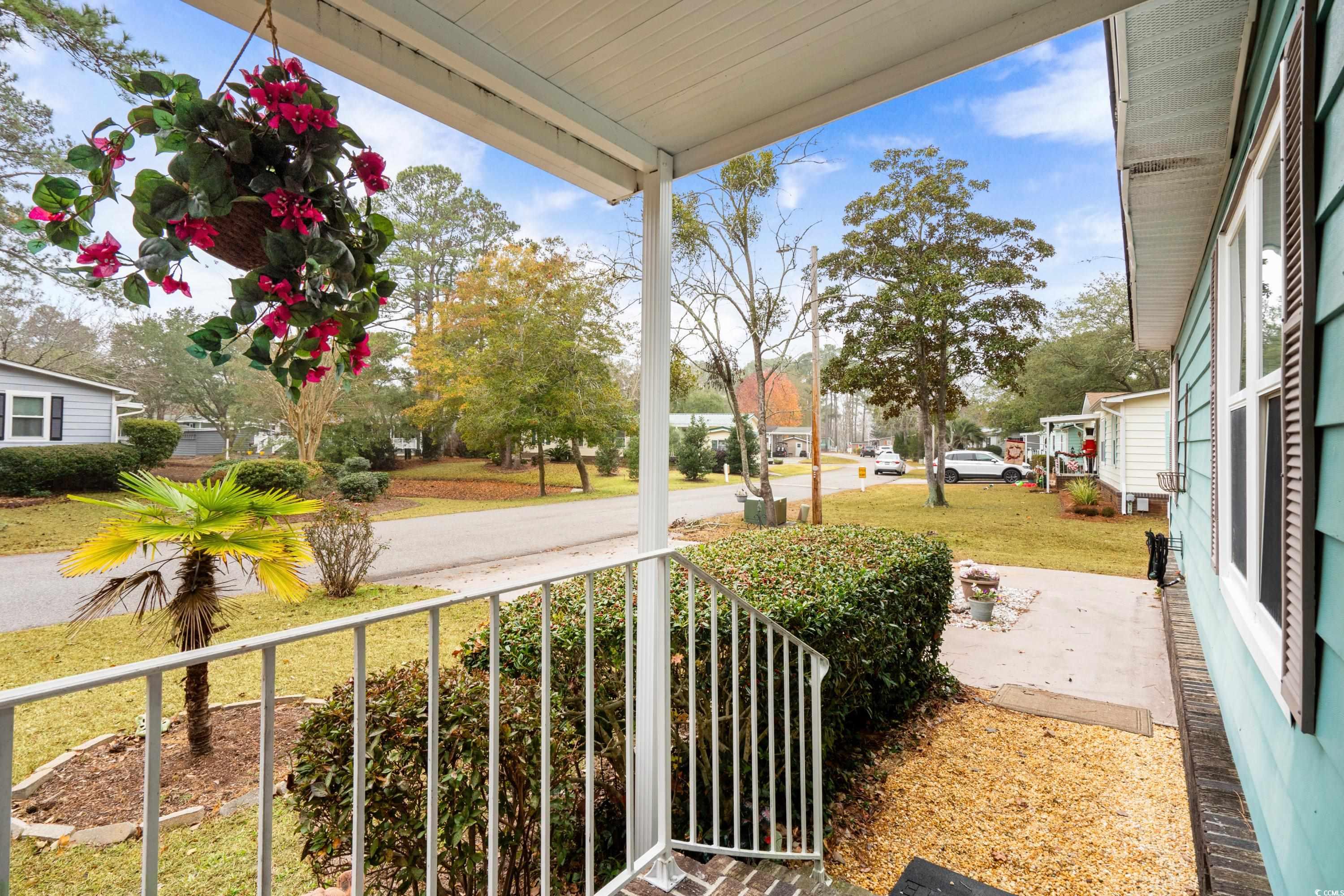 808 Carolina Drive Murrells Inlet, SC 29576 - Photo 2 of 40 View of yard featuring covered porch