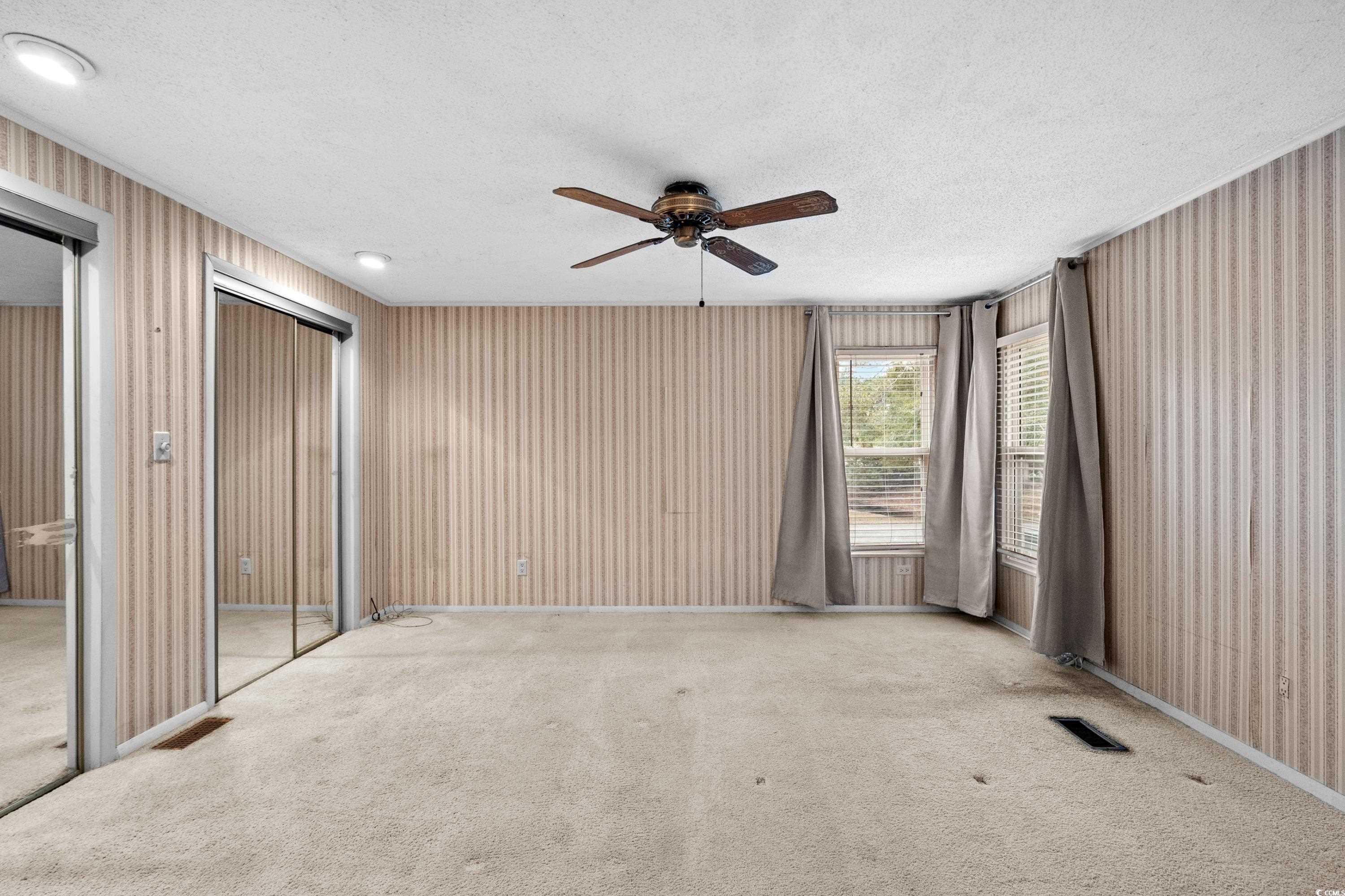 808 Carolina Drive Murrells Inlet, SC 29576 - Photo 26 of 40 Carpeted spare room with ceiling fan and a texture