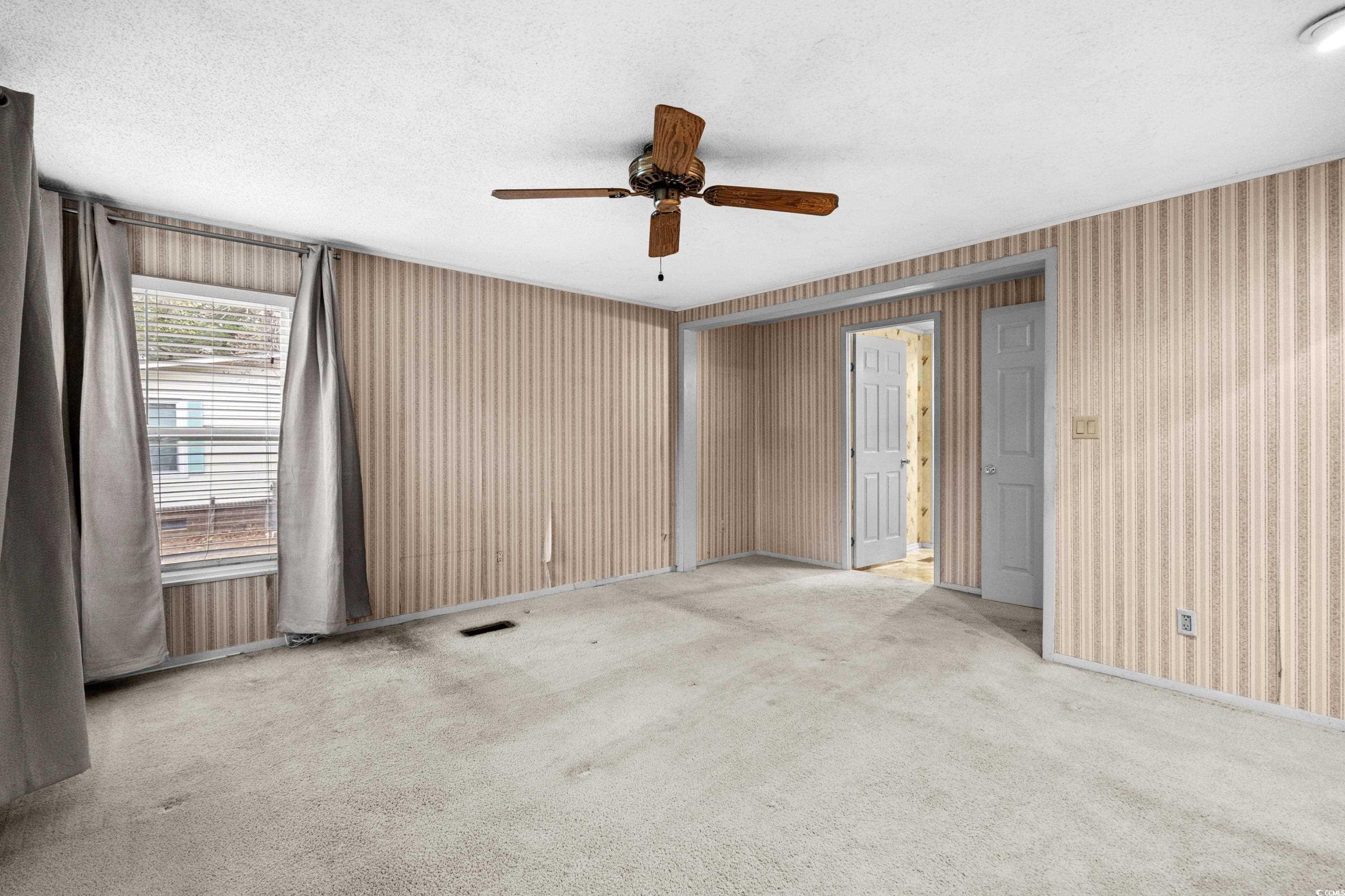808 Carolina Drive Murrells Inlet, SC 29576 - Photo 27 of 40 Spare room with ceiling fan, light colored carpet,