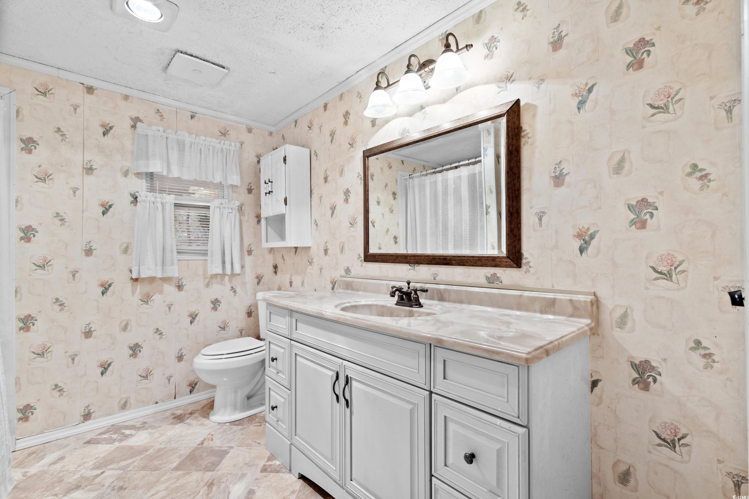 808 Carolina Drive Murrells Inlet, SC 29576 - Photo 29 of 40 Bathroom with a shower with curtain, vanity, a tex