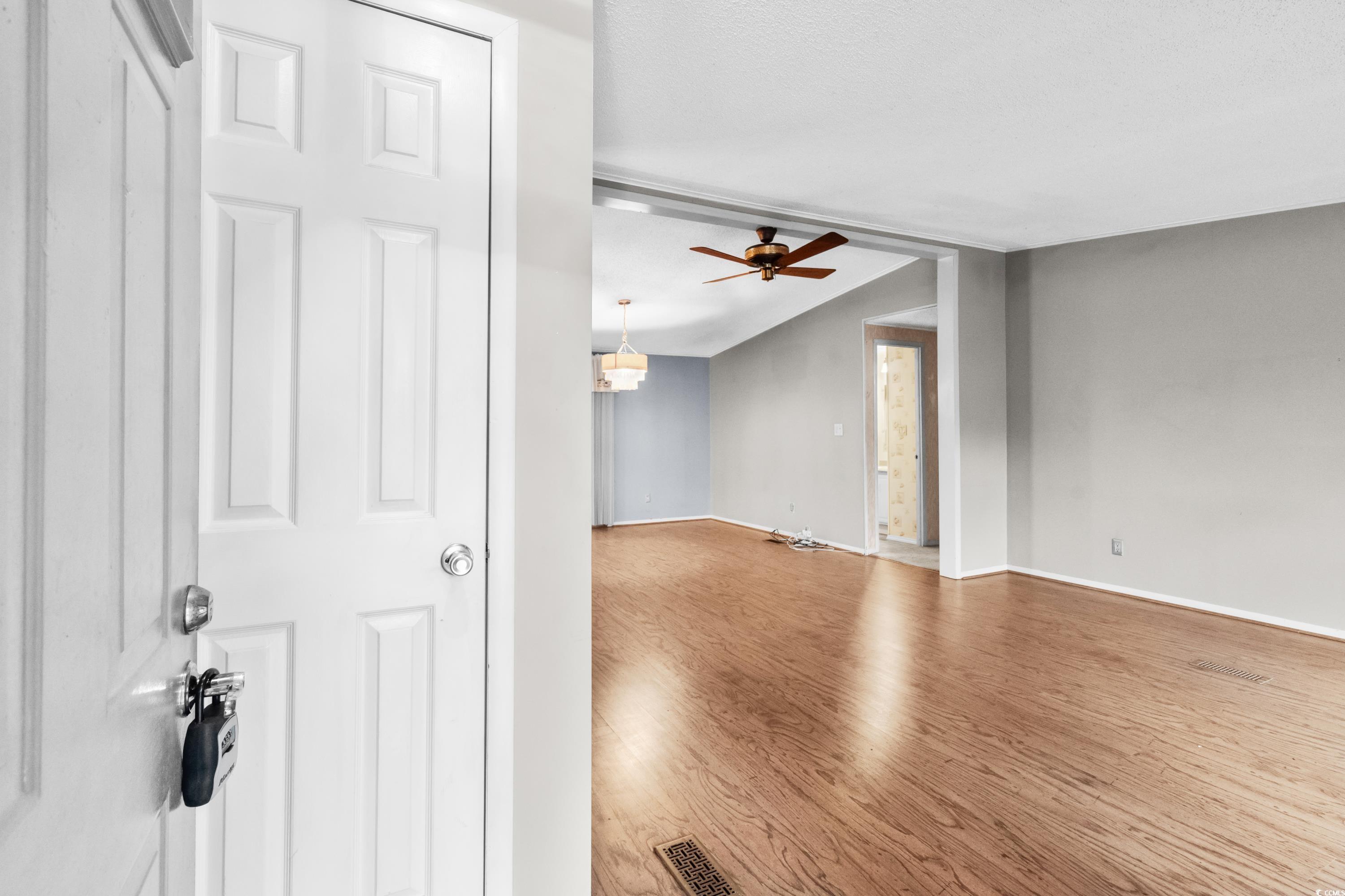808 Carolina Drive Murrells Inlet, SC 29576 - Photo 3 of 40 Empty room featuring hardwood / wood-style floorin