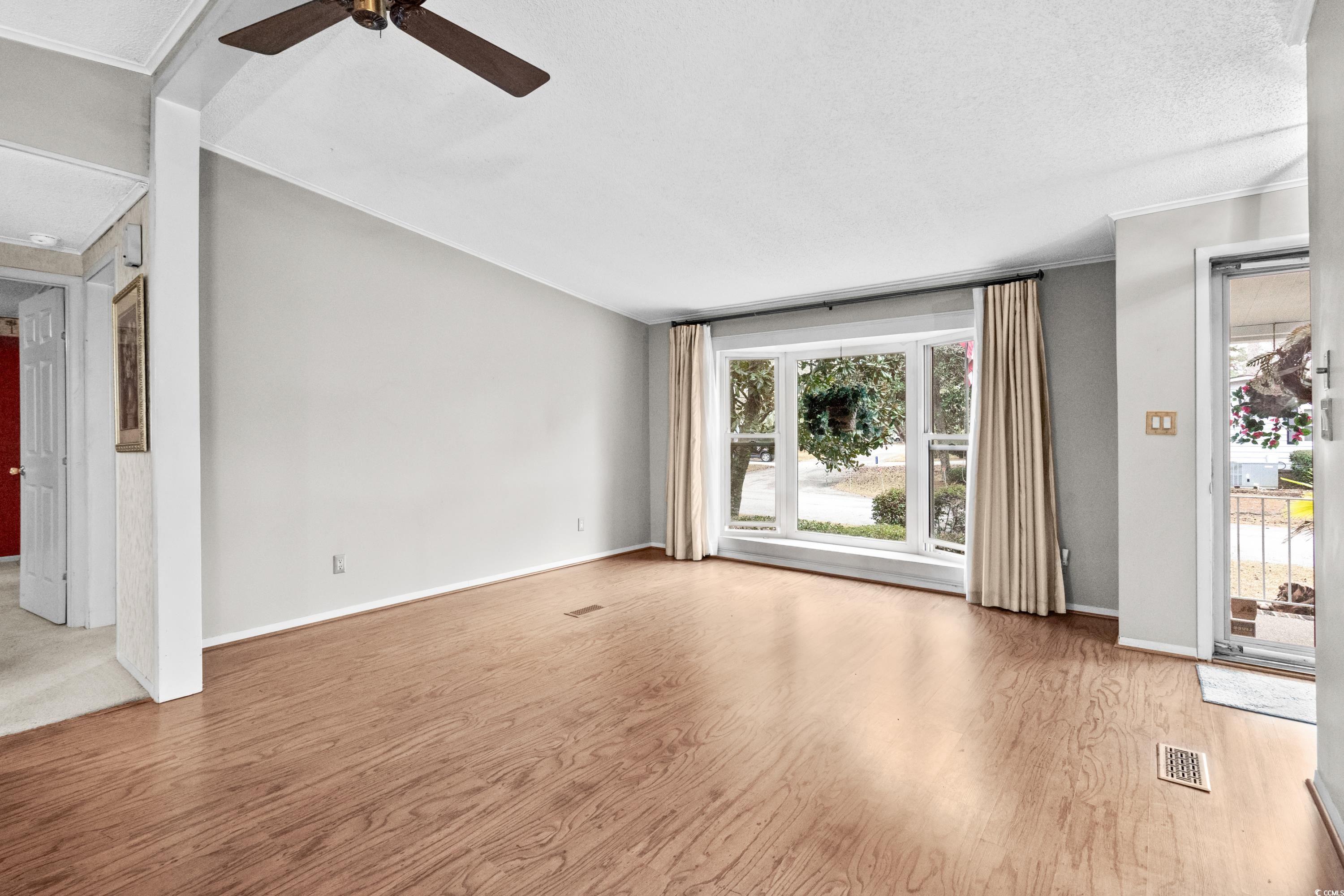 808 Carolina Drive Murrells Inlet, SC 29576 - Photo 5 of 40 Unfurnished living room with wood-type flooring, p