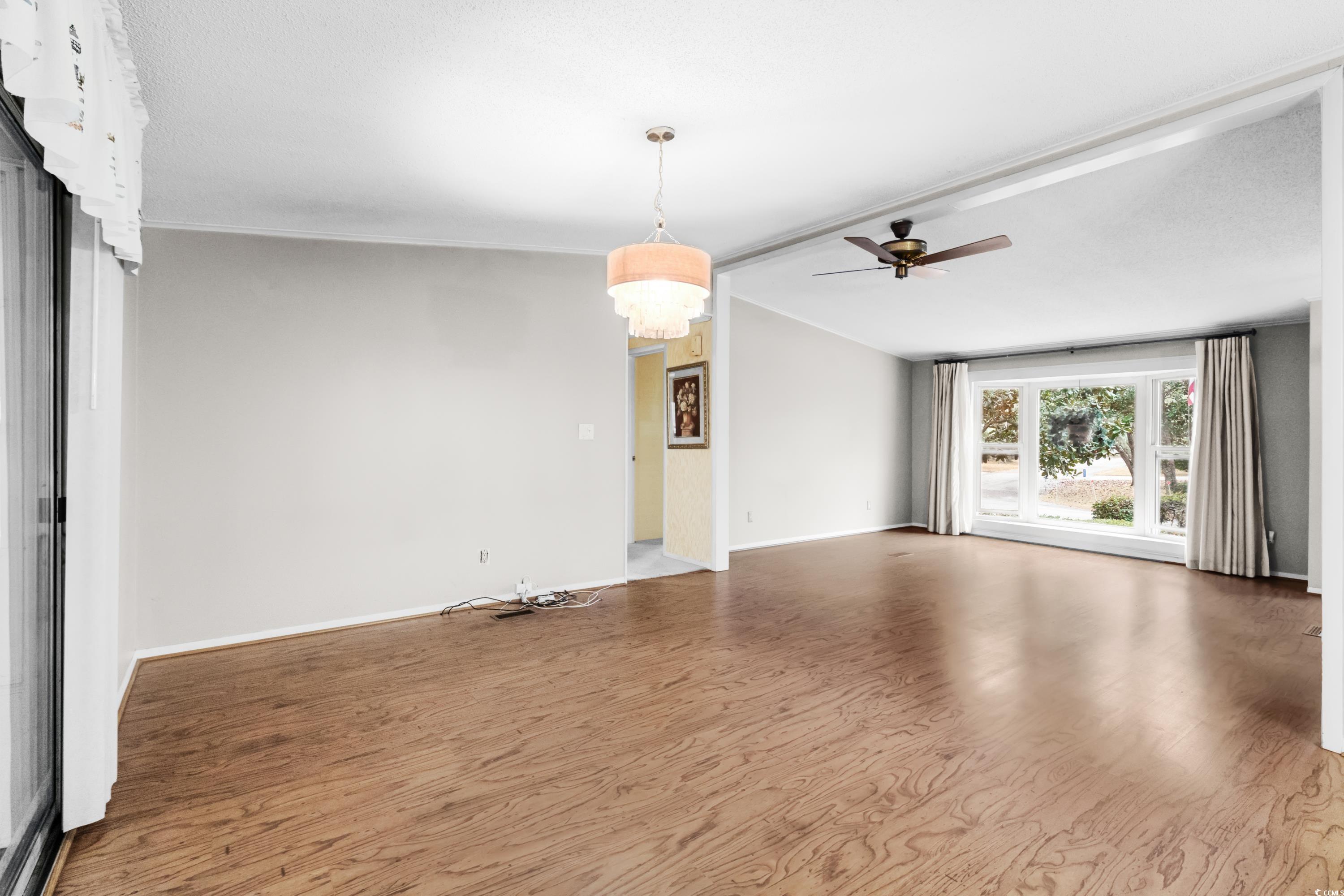 808 Carolina Drive Murrells Inlet, SC 29576 - Photo 9 of 40 Unfurnished living room featuring wood-type floori
