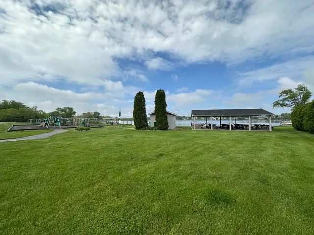 a view of a garden with tall buildings