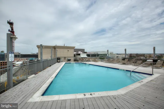 a view of a swimming pool with seating area