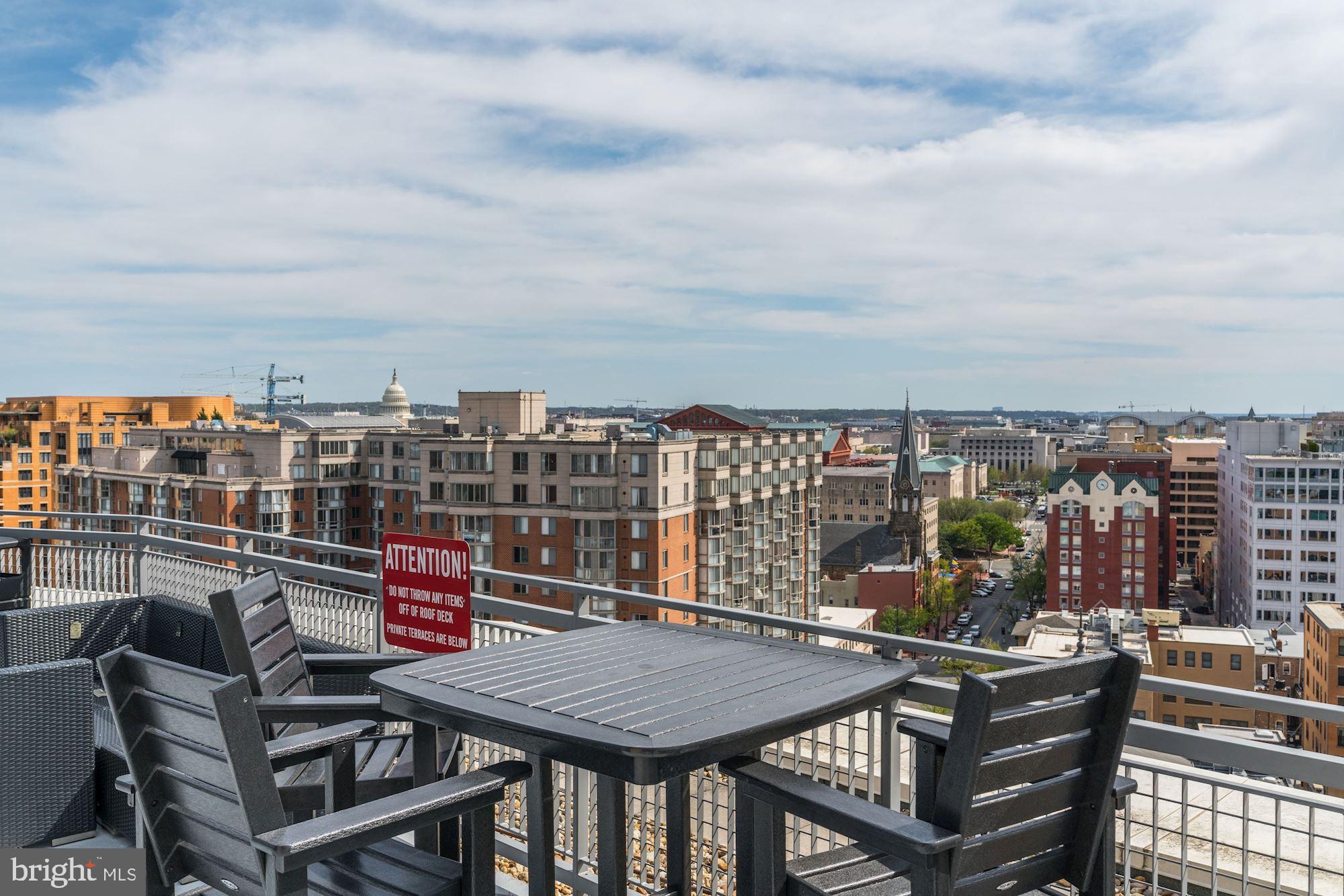555 Massachusetts Avenue Northwest, Unit 917 Washington, DC 20001 - Photo 10 of 22 a view of a balcony with a table and chairs