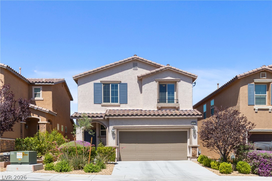 891 Earth Luster Road Las Vegas, NV 89178 - Photo 2 of 48 A well-maintained stucco home with an attached garage and colorful landscaping awaits.