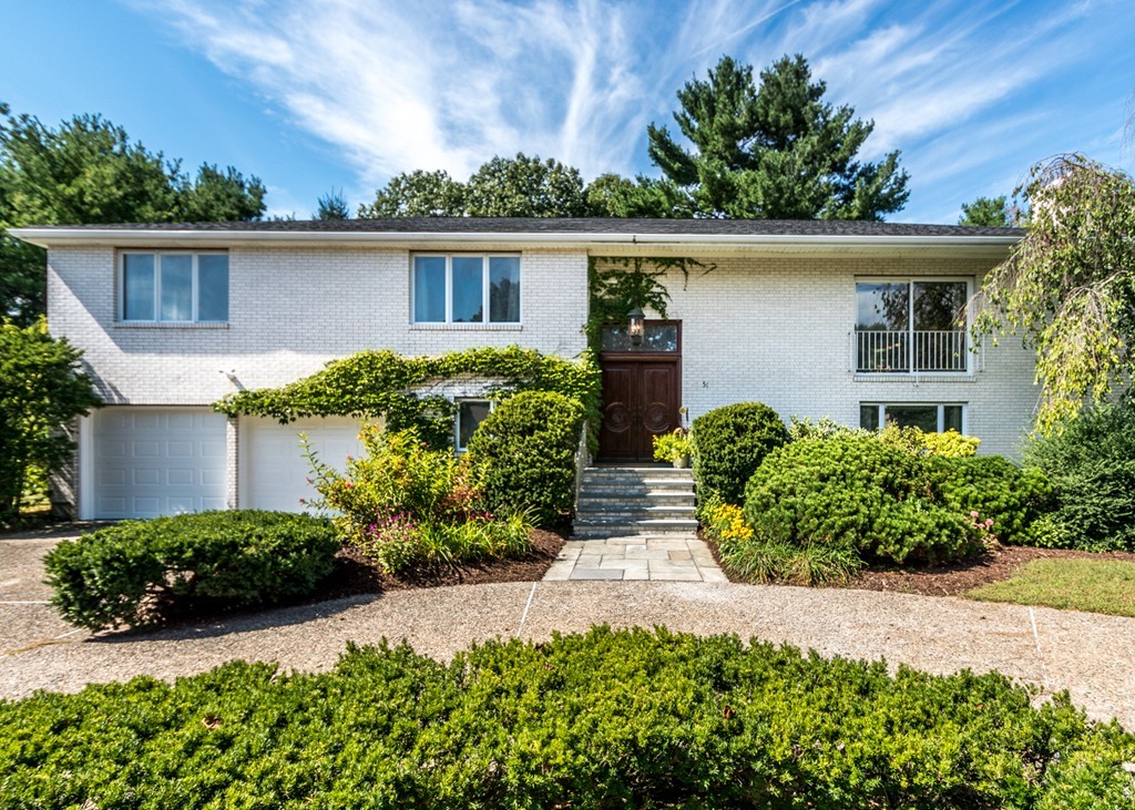 front view of a house with potted plants