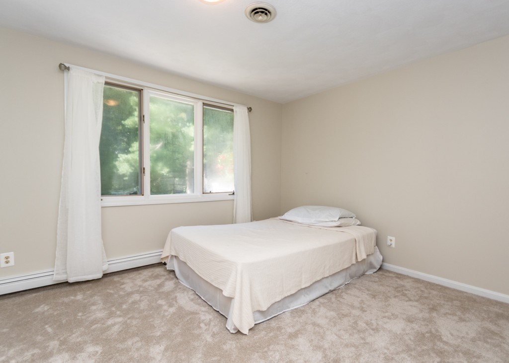 51 Mary Chilton Road Needham, MA 02492 - Photo 12 of 25 a spacious bedroom with a bed and a window