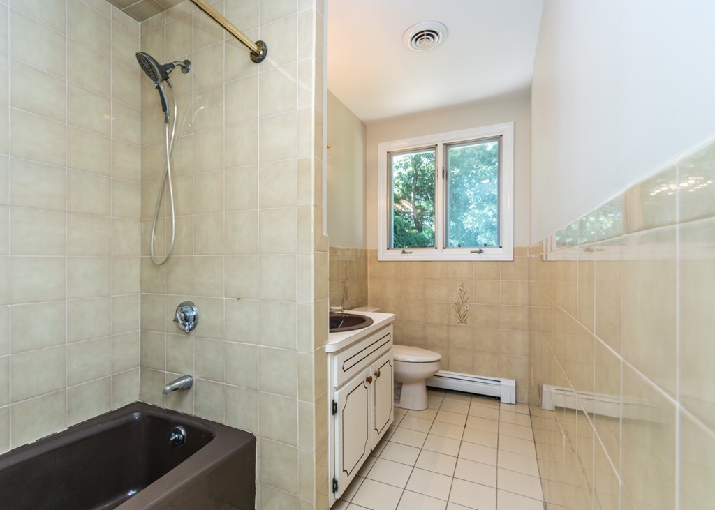 51 Mary Chilton Road Needham, MA 02492 - Photo 17 of 25 a bathroom with a tub a sink a window and a shower