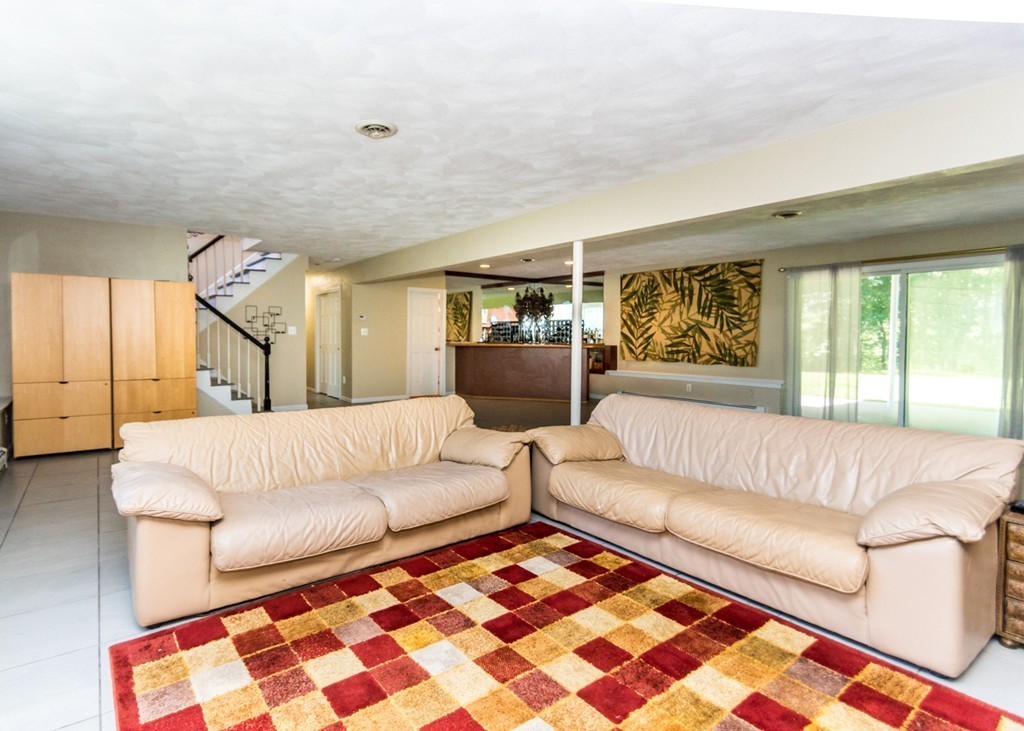 51 Mary Chilton Road Needham, MA 02492 - Photo 18 of 25 a living room with furniture and a rug