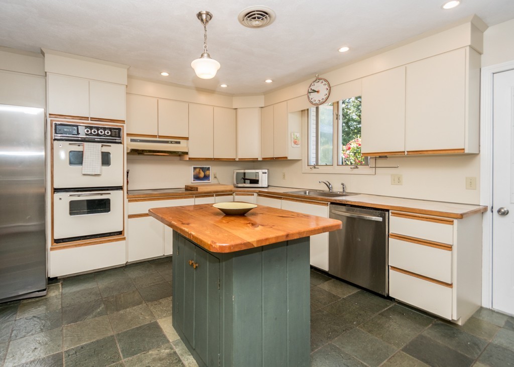 51 Mary Chilton Road Needham, MA 02492 - Photo 9 of 25 a kitchen with stainless steel appliances granite countertop a sink counter space cabinets and a large window