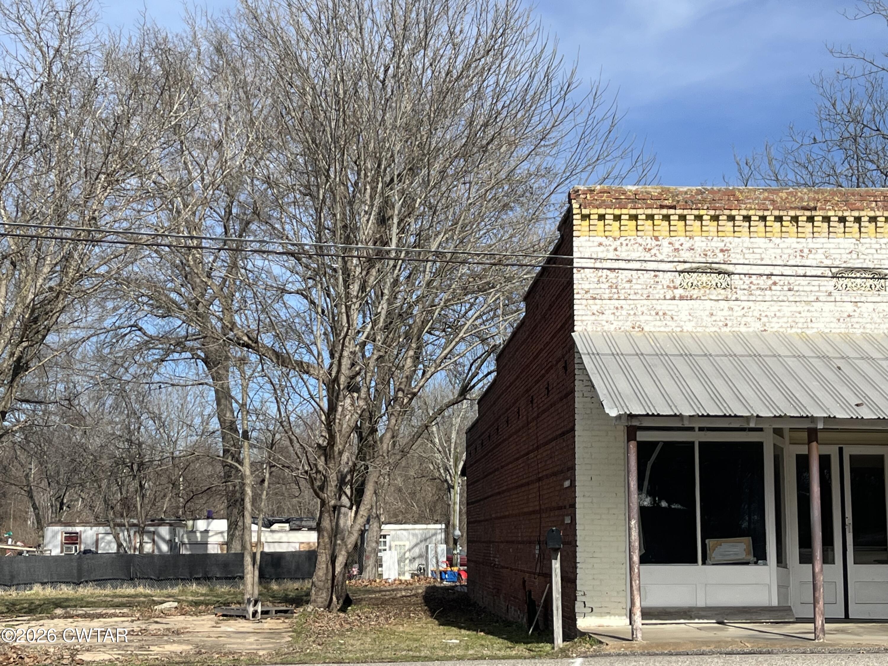 1693 Highway 138 Mercer, TN 38392 - Photo 2 of 10 a front view of a building with a yard