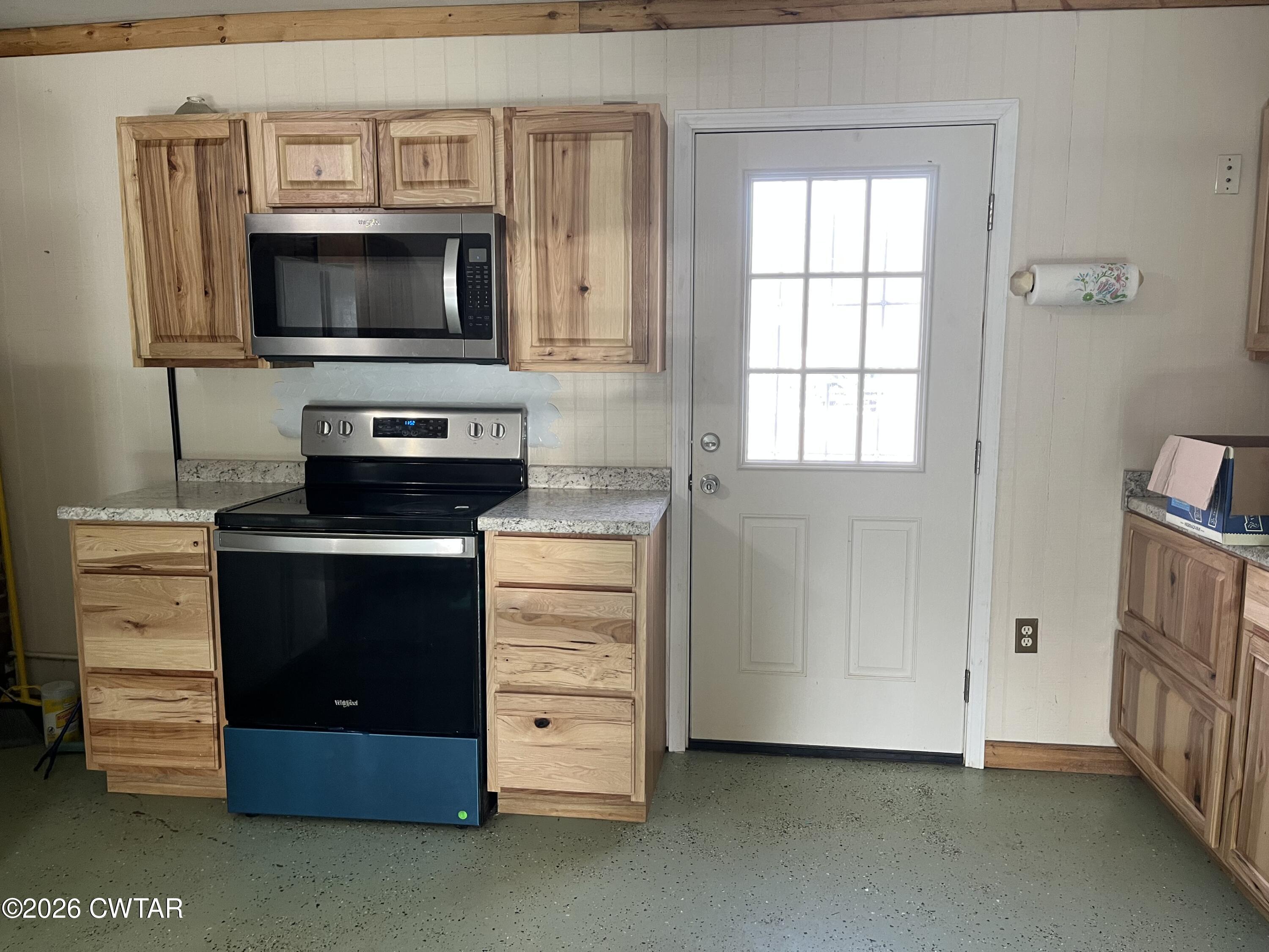 1693 Highway 138 Mercer, TN 38392 - Photo 4 of 10 a kitchen with stainless steel appliances a stove and a microwave