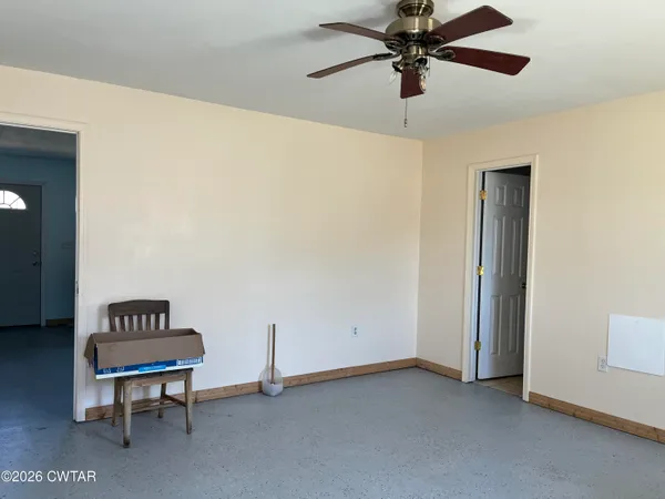 a view of a livingroom with a couch and a ceiling fan