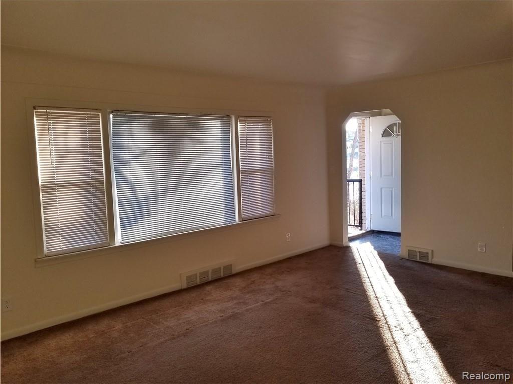 Living Room with view of Large Front Window and Entry Foyer.....