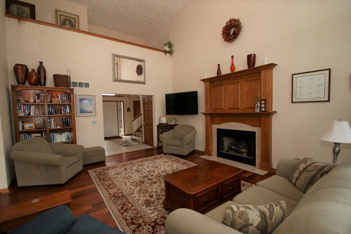 2865 Dourdan Road Belvidere, IL 61008 - Photo 7 of 24 a living room with furniture a flat screen tv and a fireplace