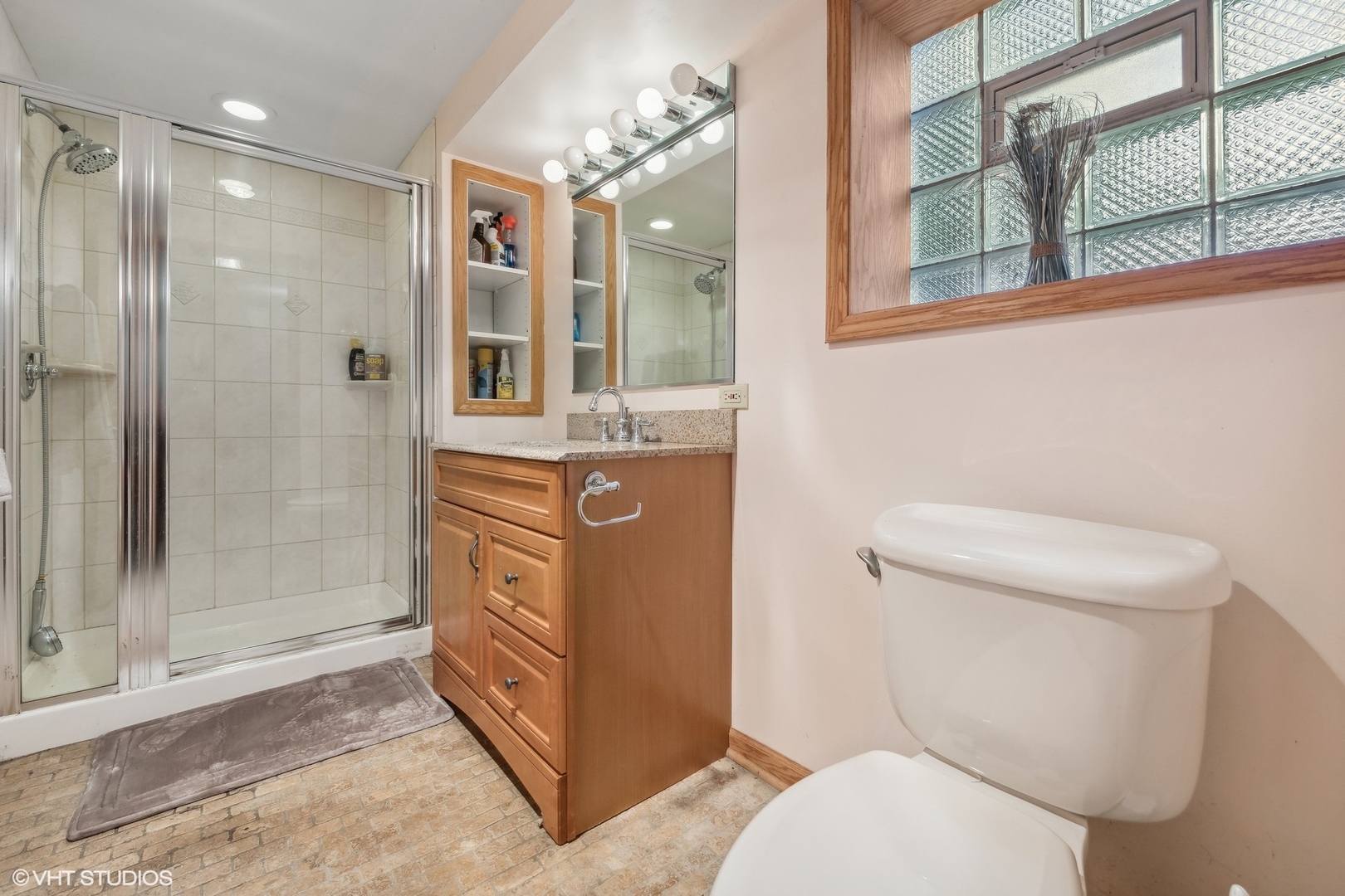30 Northgate Road Riverside, IL 60546 - Photo 12 of 20 a bathroom with a toilet a sink and glass door shower