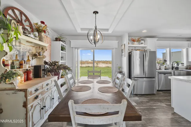 a view of a dining room with furniture wooden floor and a chandelier