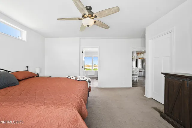 a large white kitchen with a large window