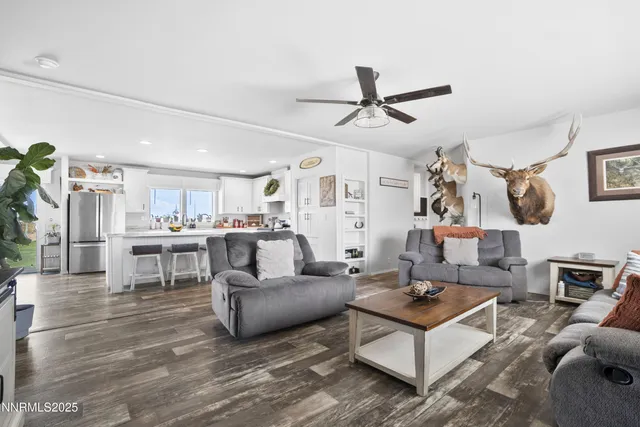 a living room with furniture and a view of kitchen