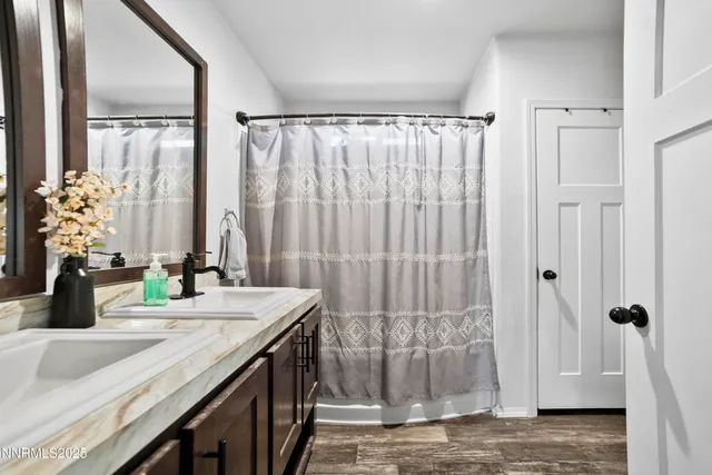 a view of a hallway with wooden floor and cabinet