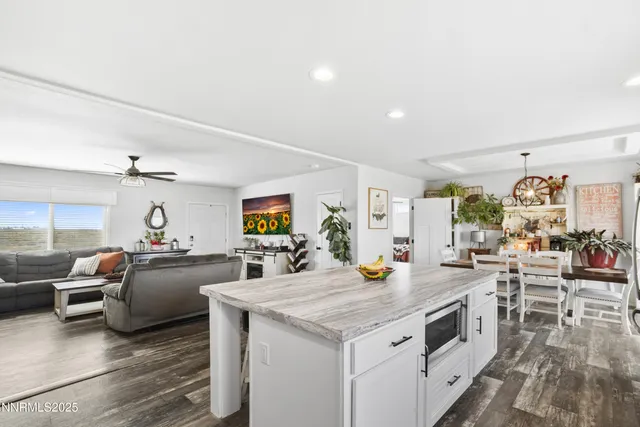 a kitchen with kitchen island a sink a stove and refrigerator
