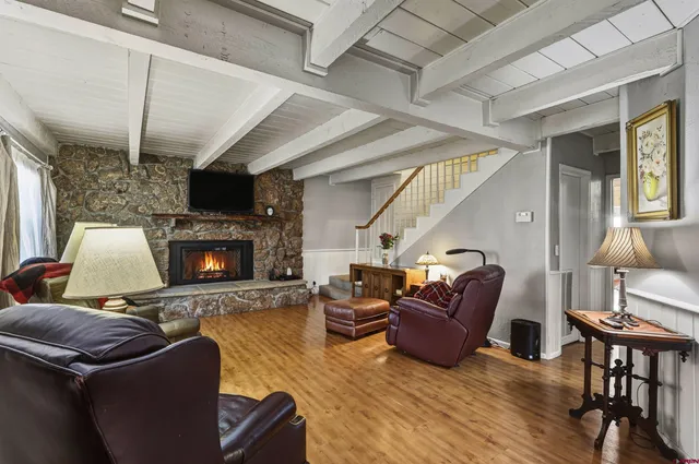 a dining room with furniture a chandelier and wooden floor