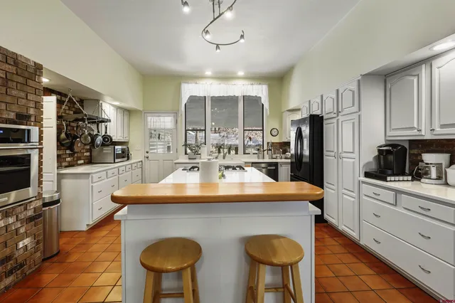 a kitchen with a stove and a wooden floor