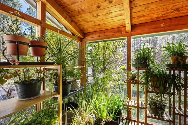 a bed sitting in a spacious bedroom next to a window