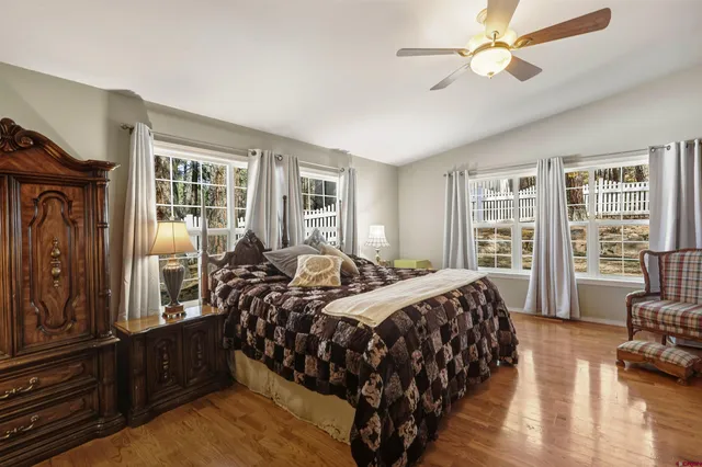 a bed room with a bed a couch and a chandelier