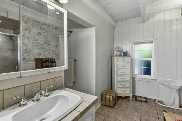 a bath tub sitting in a bathroom next to a window