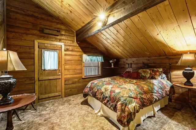 a bed room with a bed and a mirror