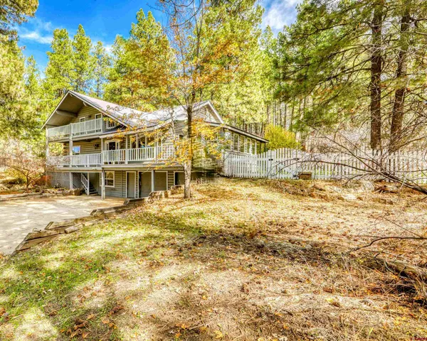 a view of a house with pool and sitting area