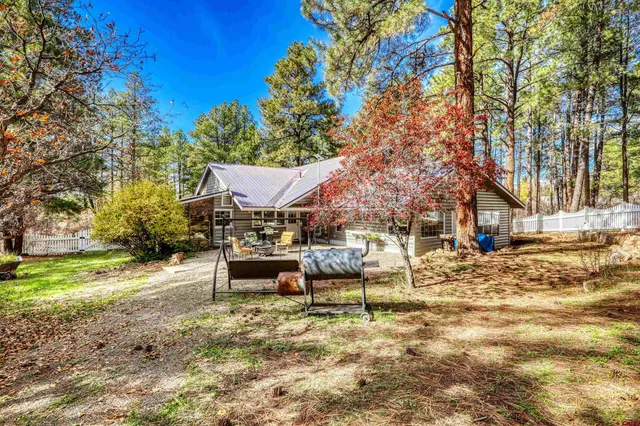 a view of a house with a yard and sitting area