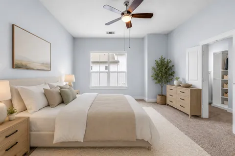a bedroom with a large bed and a window